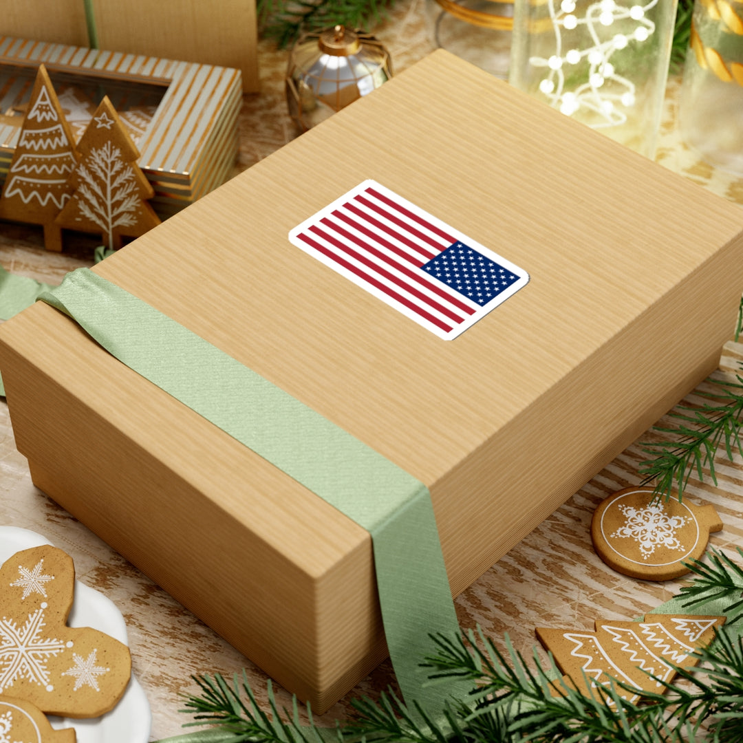 Gift box with American flag sticker on a festive background with cookies and greenery
